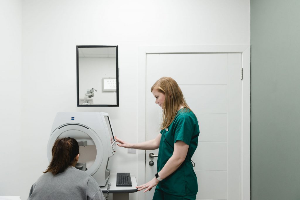 Gemma Hill performing a sight examination with a customer